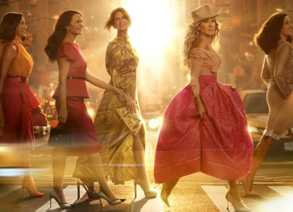 Carrie Bradshaw standing in her upscale apartment from And Just Like That, looking lost and glamorous, reflecting the tone of season 3