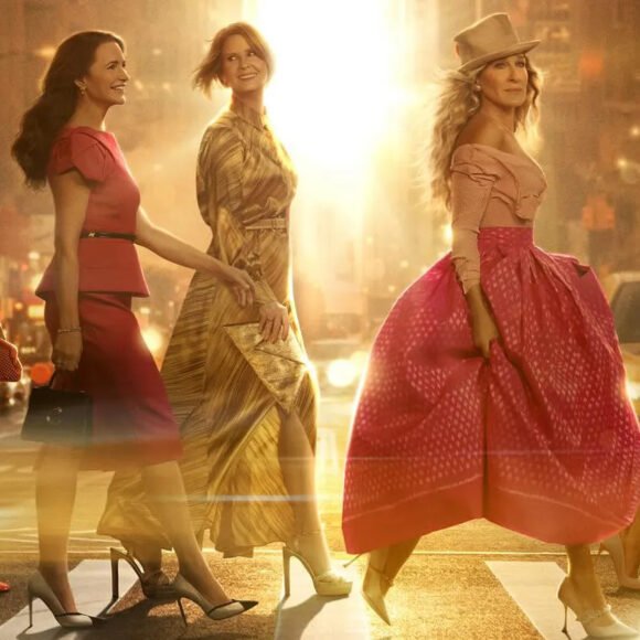 Carrie Bradshaw standing in her upscale apartment from And Just Like That, looking lost and glamorous, reflecting the tone of season 3